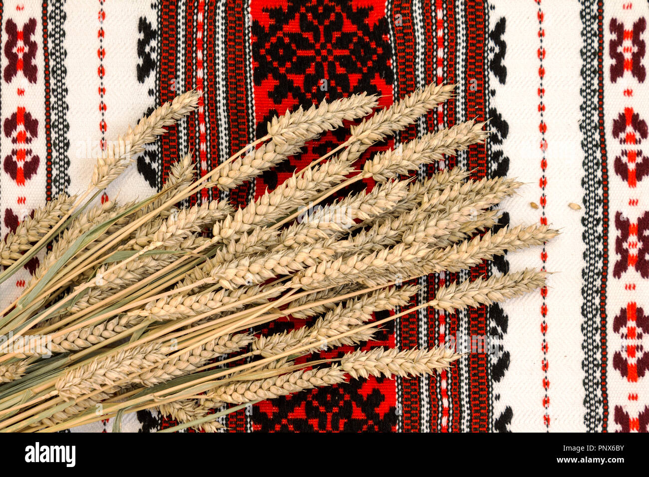 Wheat on ethnic ukrainian traditional ornate background Stock Photo
