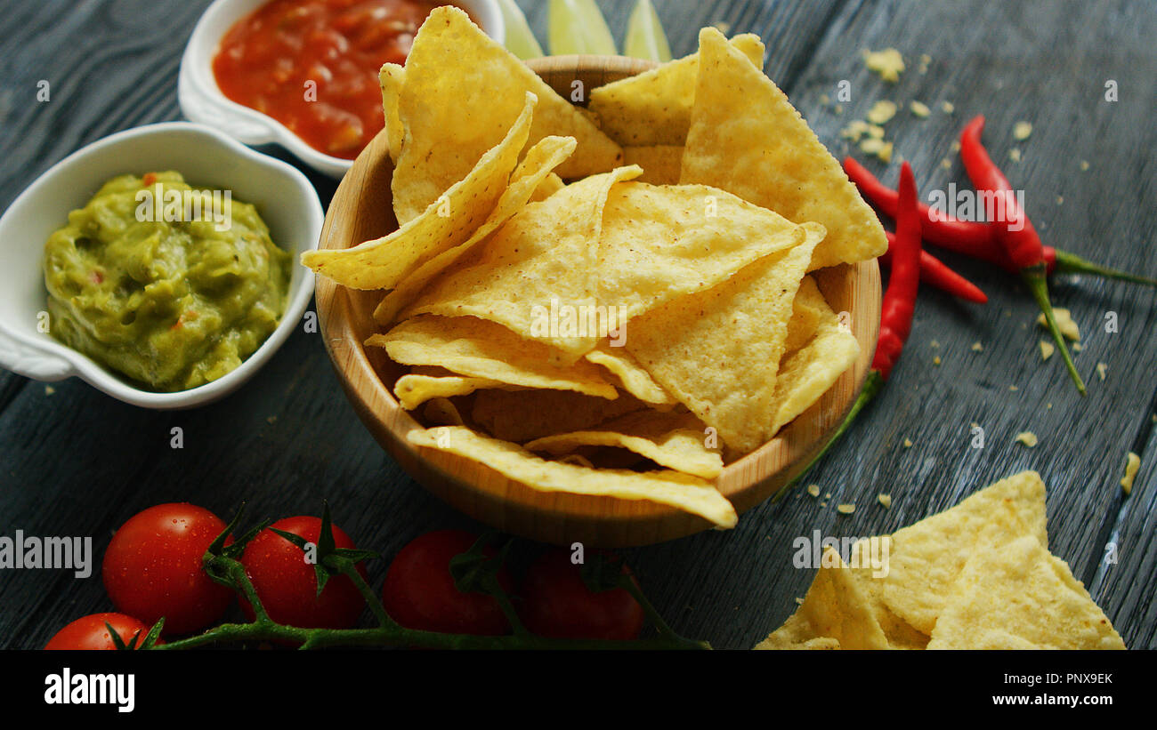 Nachos and sauces on table  Stock Photo