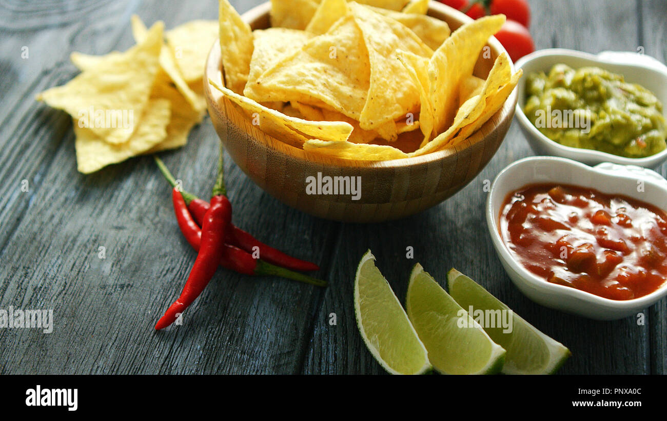 Delicious nachos and sauces on table Stock Photo