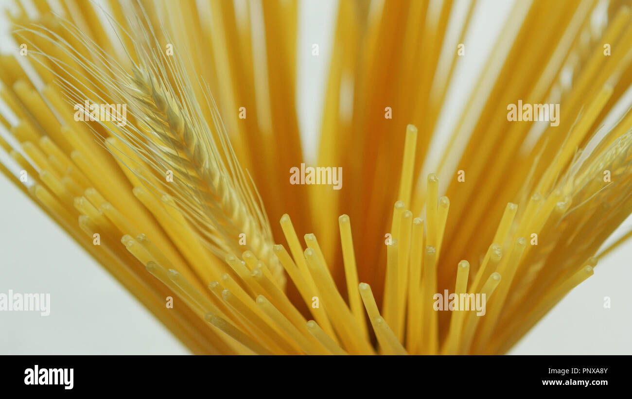Bunch of uncooked spaghetti and wheat Stock Photo