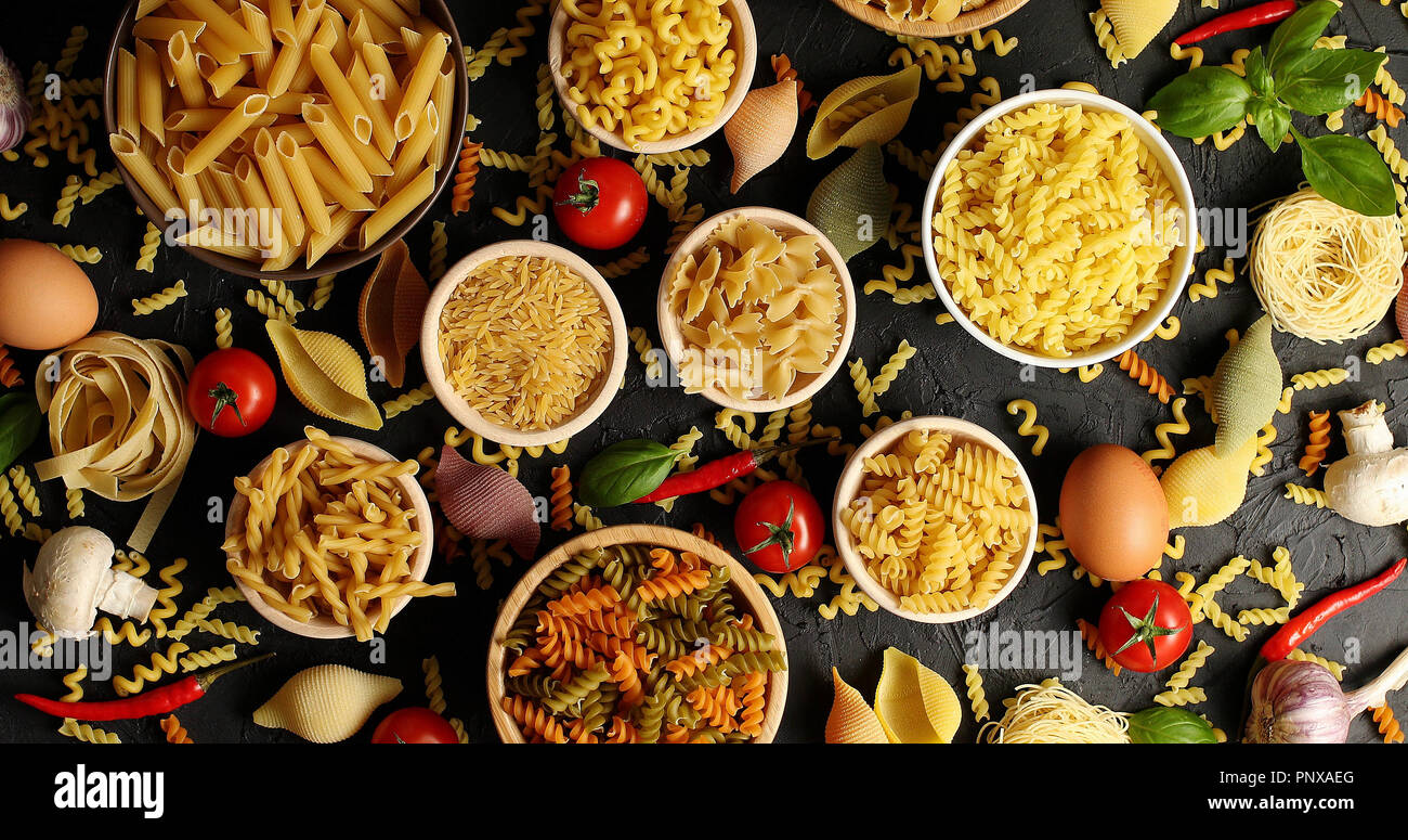 Layout of pasta and ingredients for cooking Stock Photo