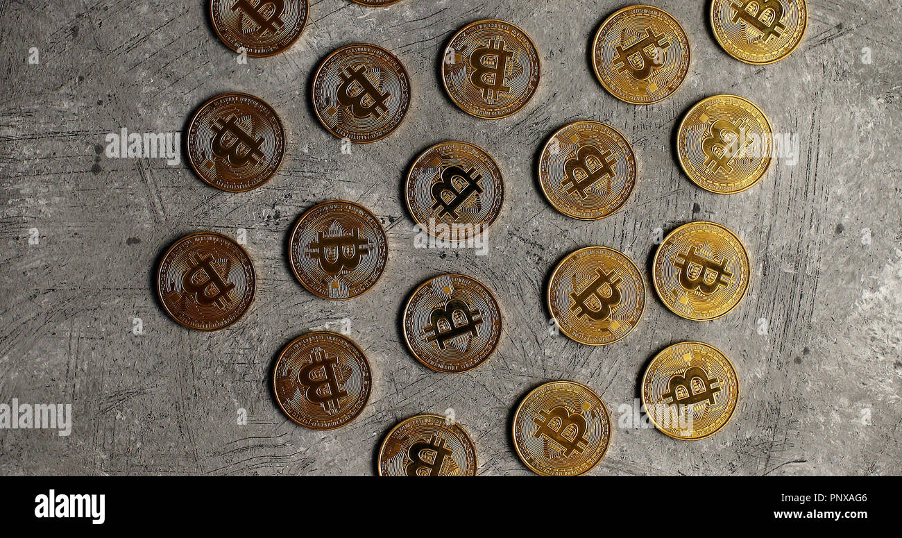 Golden bitcoins on gray surface Stock Photo
