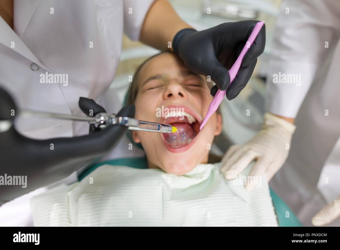 Dentist makes anesthetic injection in the gum, close up Stock Photo Alamy