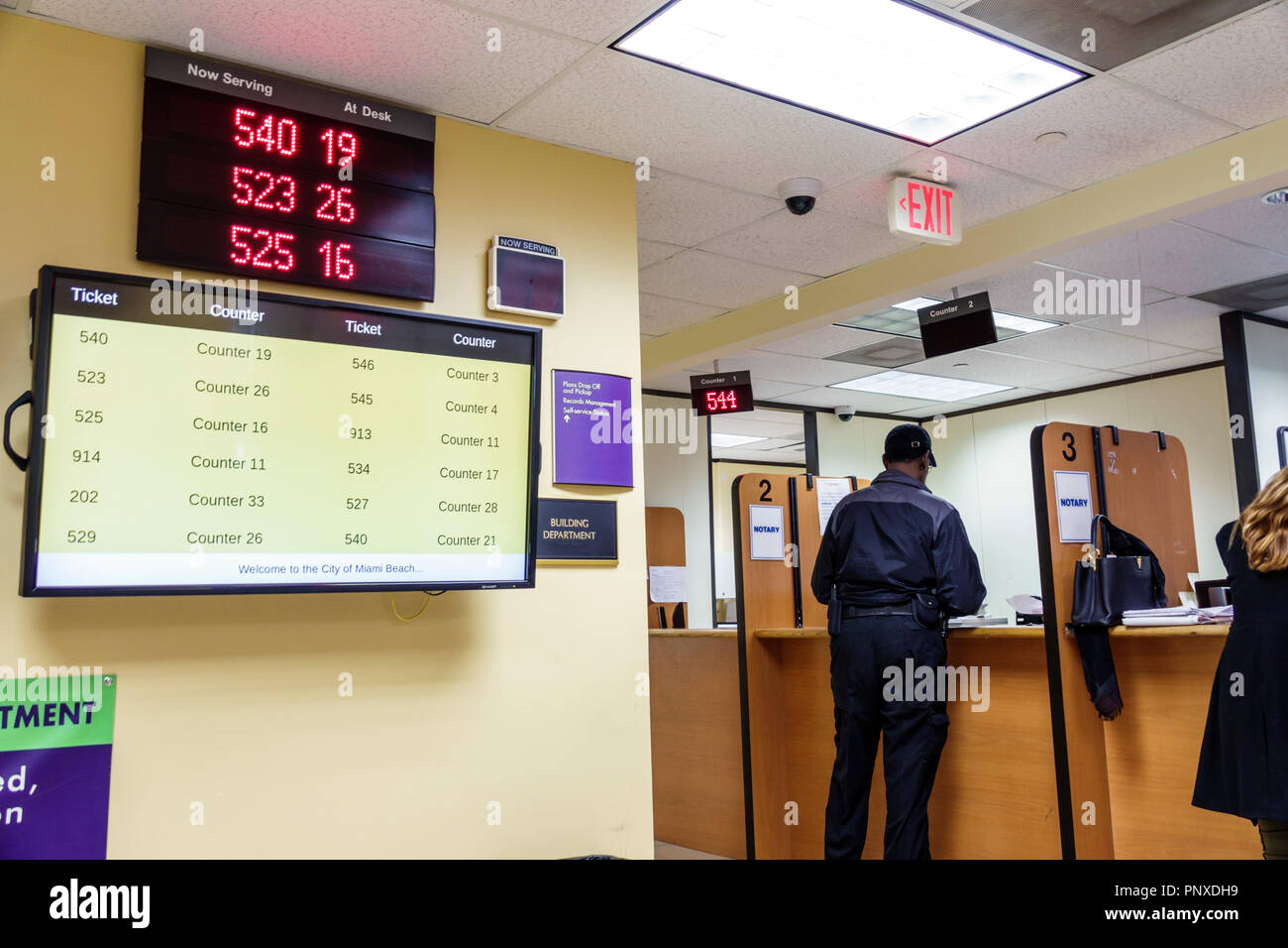 Miami Beach Florida,City Hall,building permit department,now serving,waiting turn,counter,FL180201007 Stock Photo