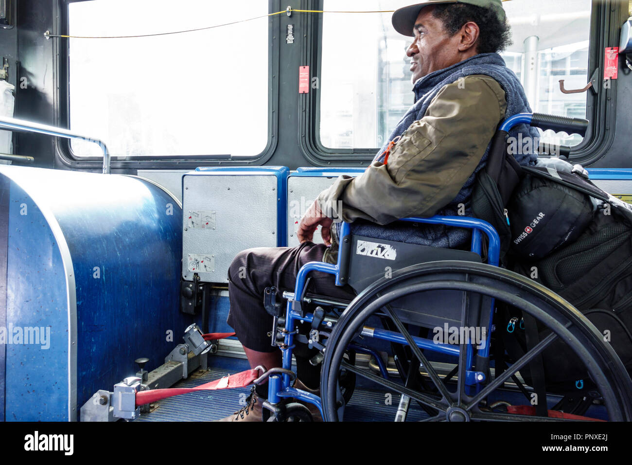 Miami Beach Florida,bus,passenger passengers rider riders,disabled handicapped special needs,Miami-Dade Metrobus rider,wheelchair,Black man men male,s Stock Photo