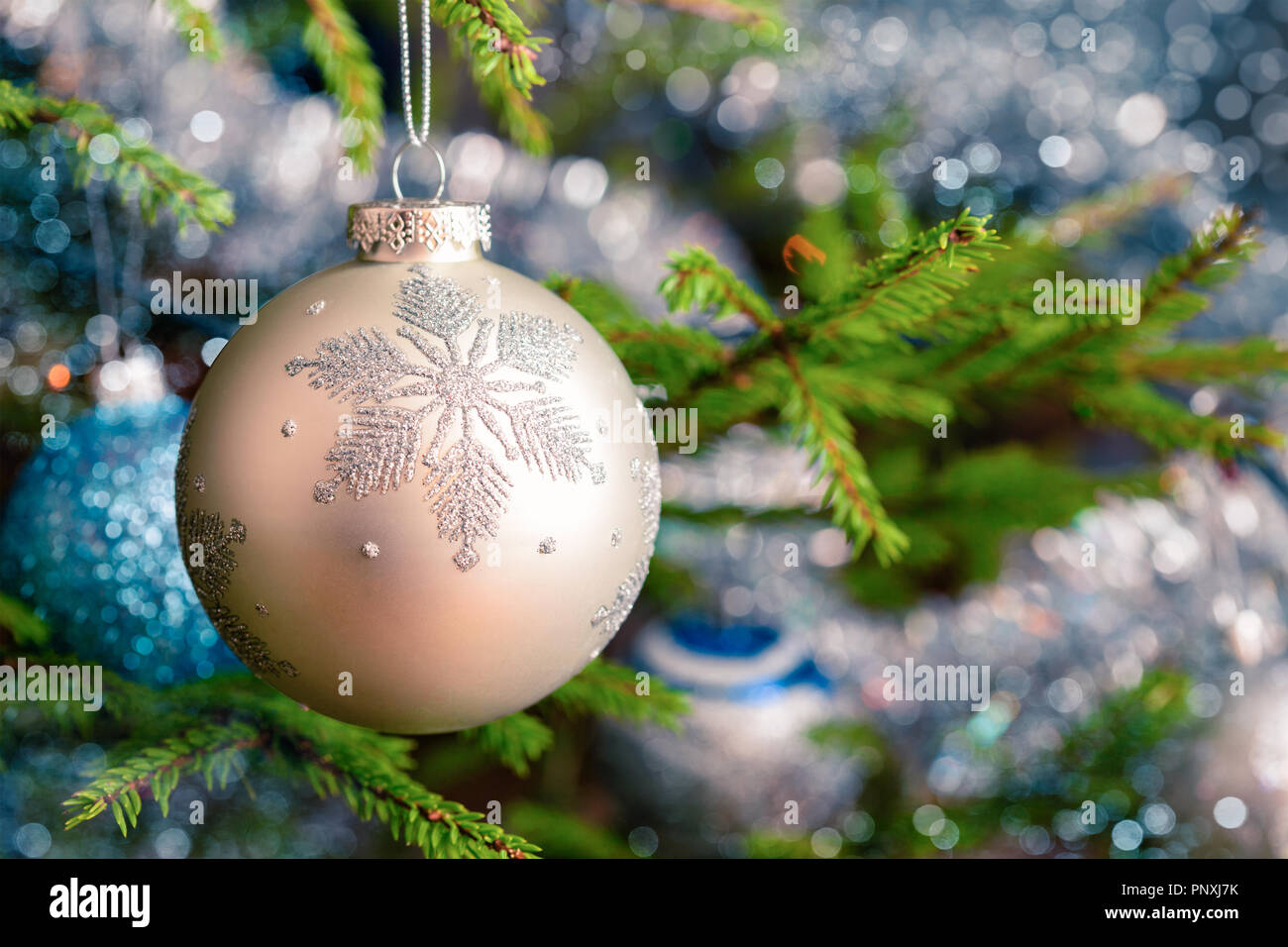 Christmas-tree decoration bauble on decorated Christmas tree bac Stock Photo