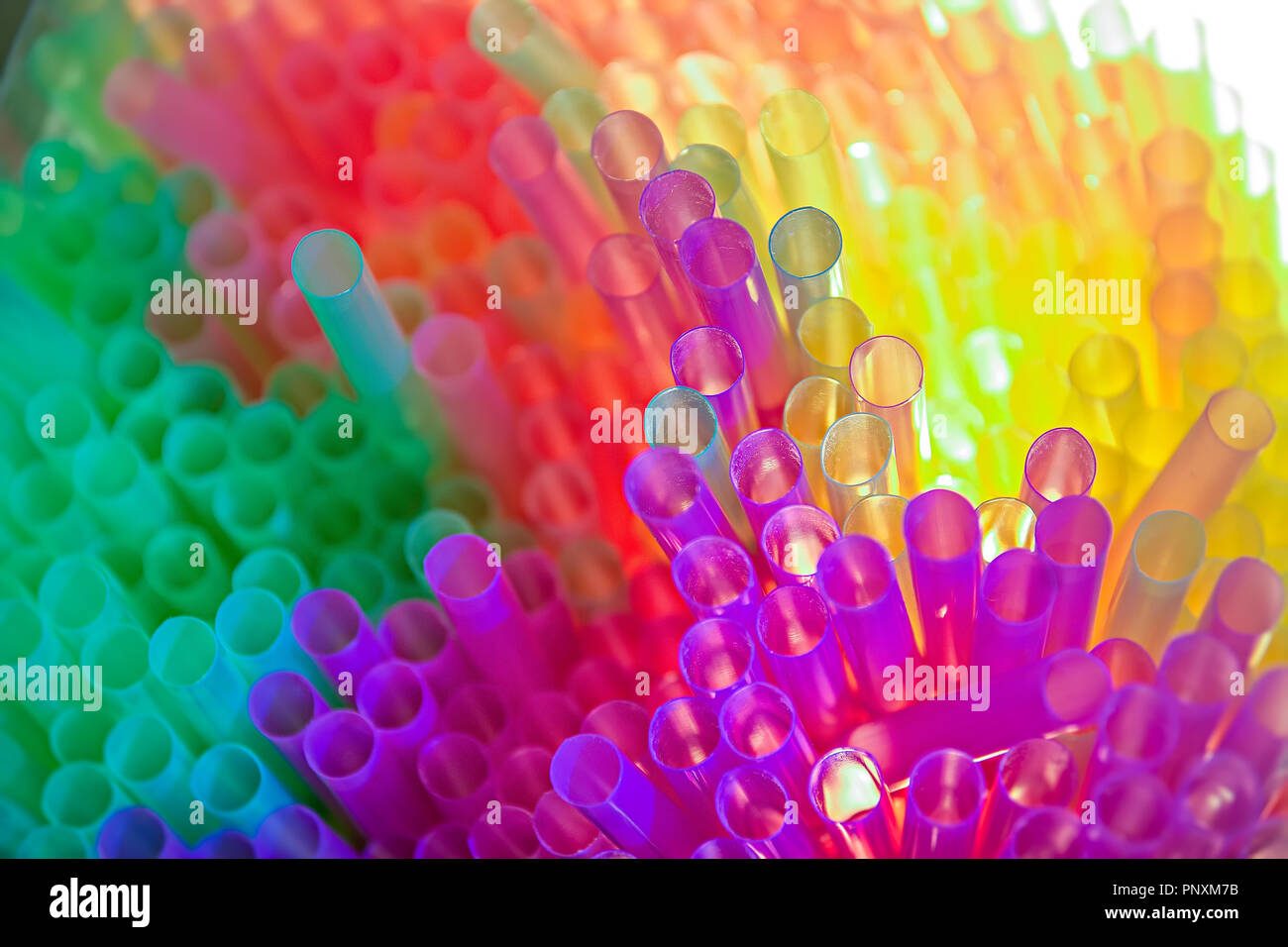 Abstract image of light illuminating coloured drinking straws. Stock Photo