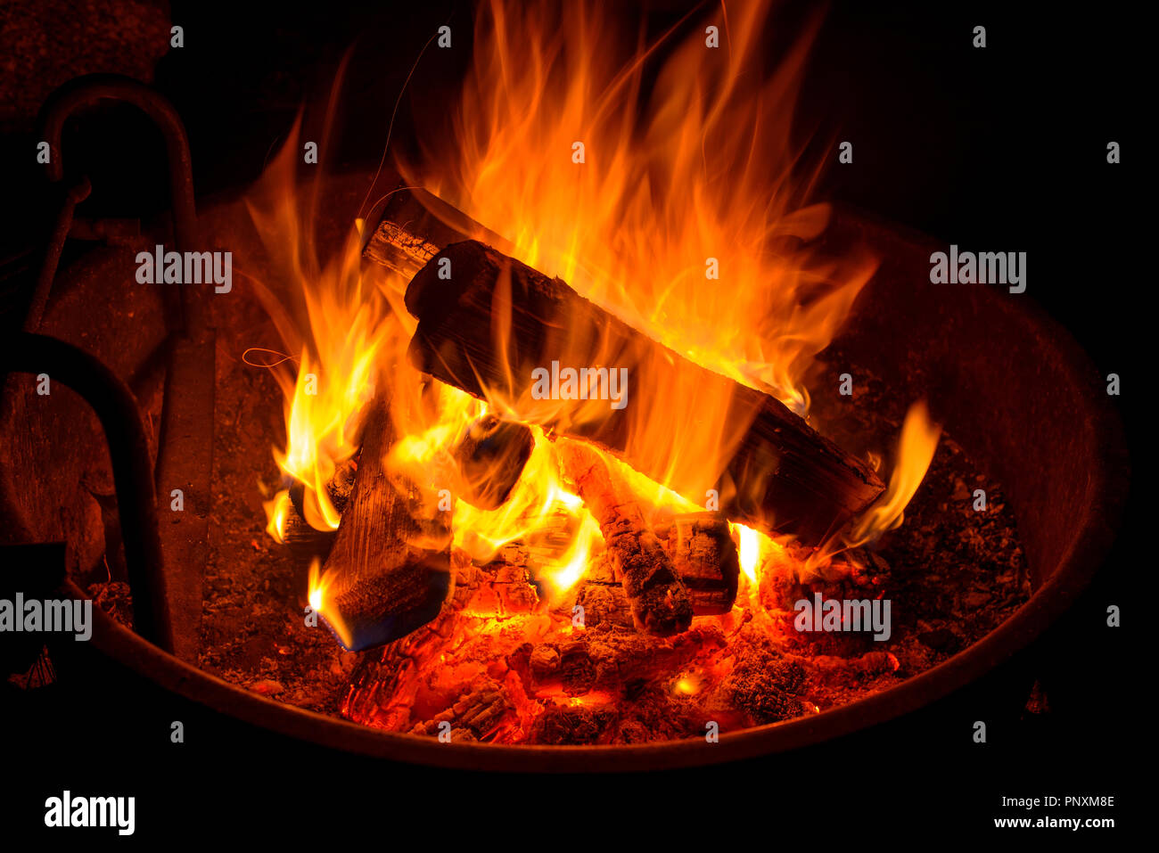Campfire - Close up view of bright wood fire burning in a camp fire pit. Stock Photo