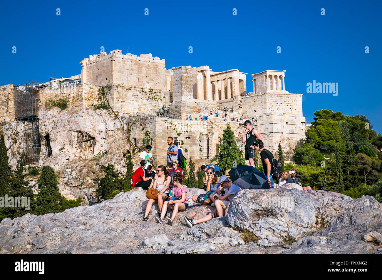 Athens, Greece - June 18, 2016: The tourist group listens to a fascinating excursion on the Areopagus Hill. Athens , Greece. Stock Photo