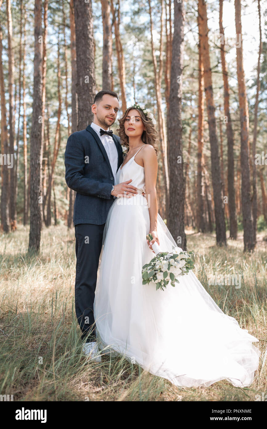Bride and groom at wedding Day walking Outdoors on summer nature. Bridal  couple, Happy Newlywed woman and man embracing in green park. Loving  wedding Stock Photo - Alamy