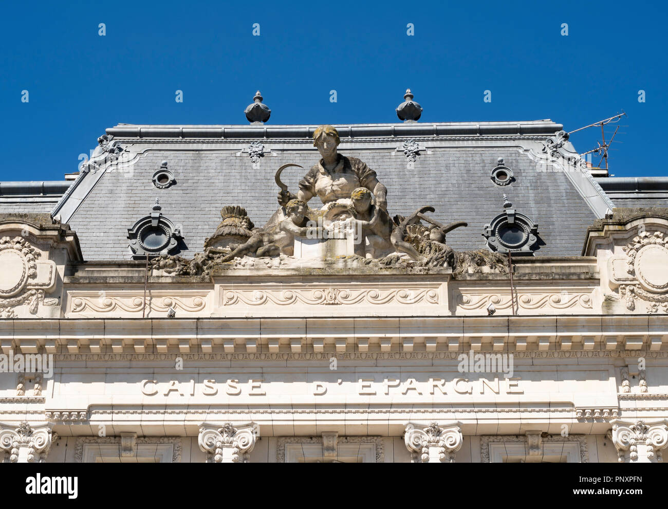 Sculpture of female farmer reaping her crop above the Caisse D'Epargne de Bourgogne building in Auxerre, Burgundy, France, Europe Stock Photo