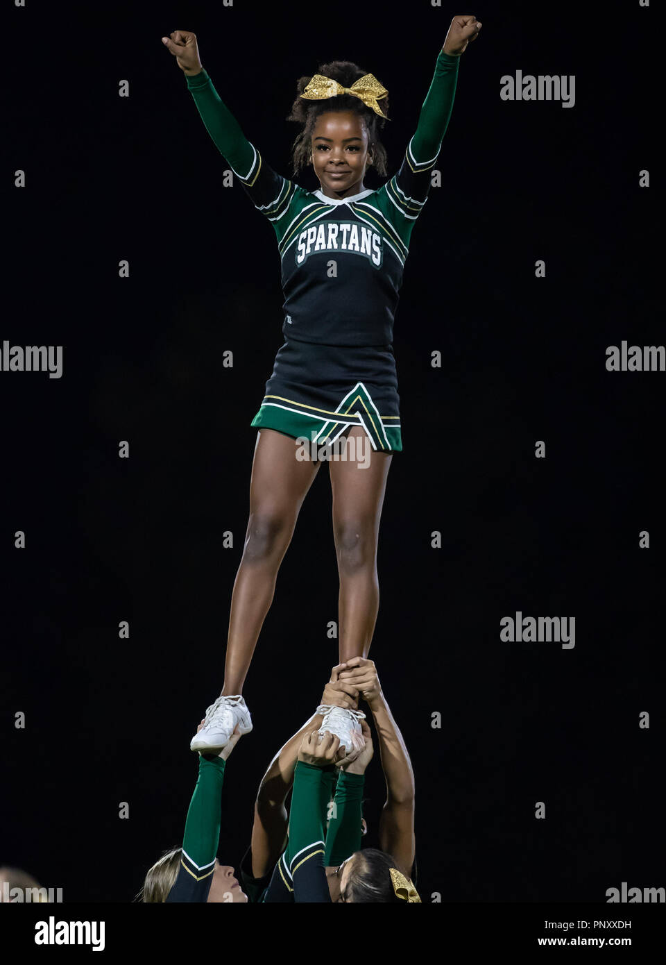 High school cheerleaders performing at a football game in Red Bluff