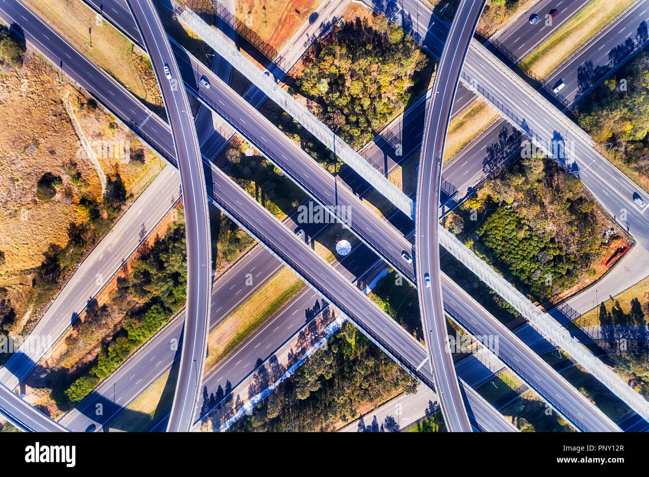 Bridges and ramps of Lighthourse interchange multi-lanes intersection of M4 and M7 in Sydney West seen top down from above. Stock Photo