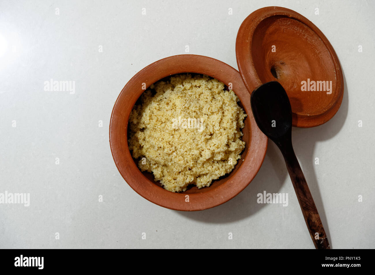 Porridge in an earthenware pot. Traditional, wholesome food , cooked and served in clay pot Stock Photo