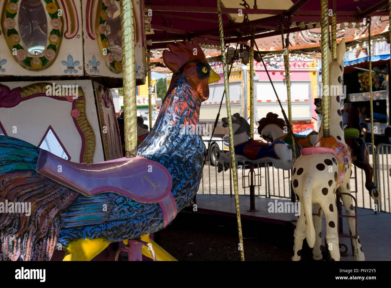 Rooster featured on carousel ride at Ocean Drive Pavilion Amusement Park sign at North Myrtle Beach South Carolina USA. Stock Photo