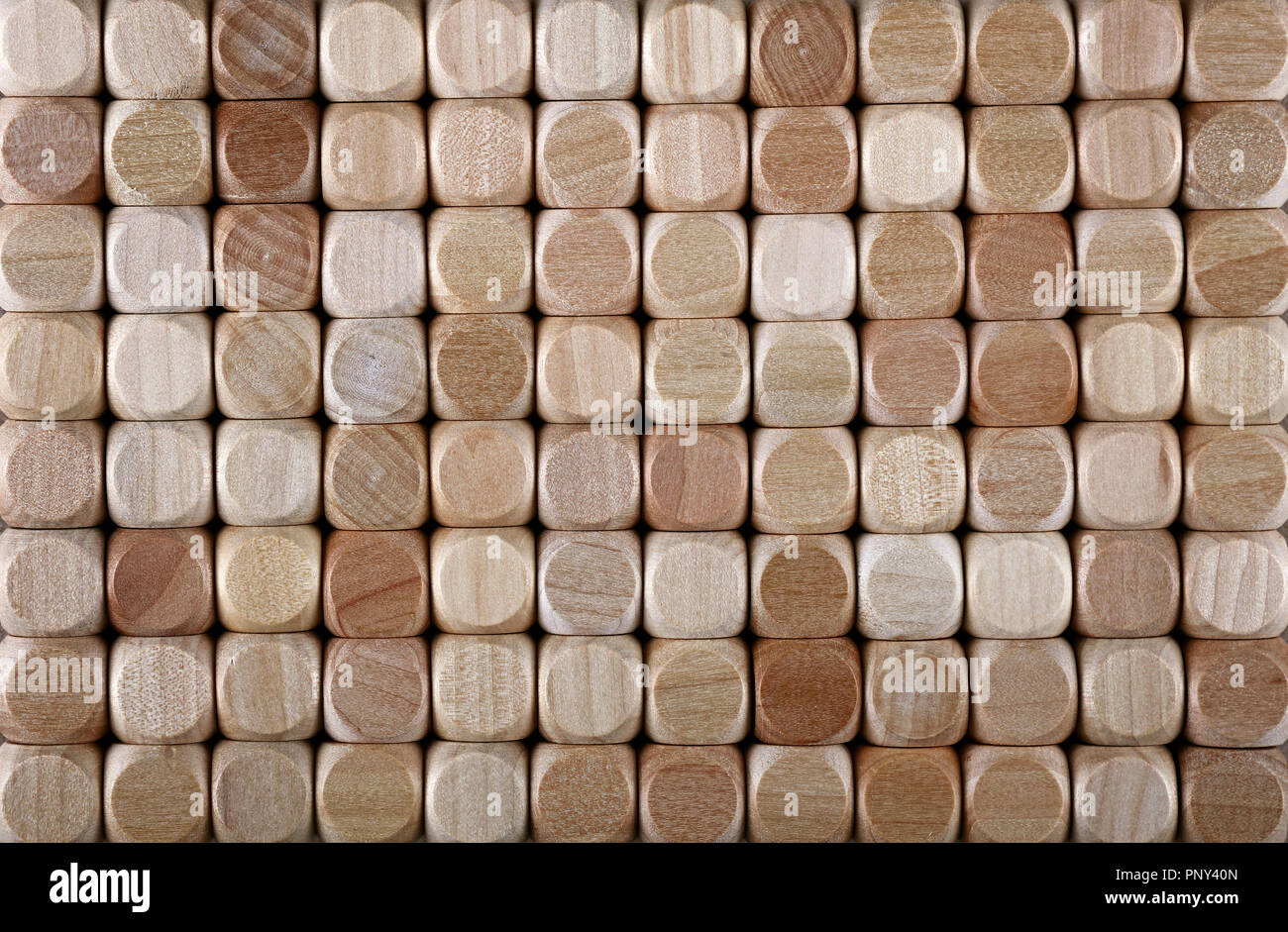 Close up background pattern of natural wooden dice shaped toy building blocks, elevated high angle view, directly above Stock Photo