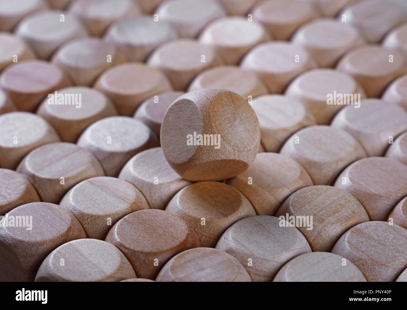 Close up background pattern of natural wooden dice shaped toy building blocks, high angle view perspective Stock Photo