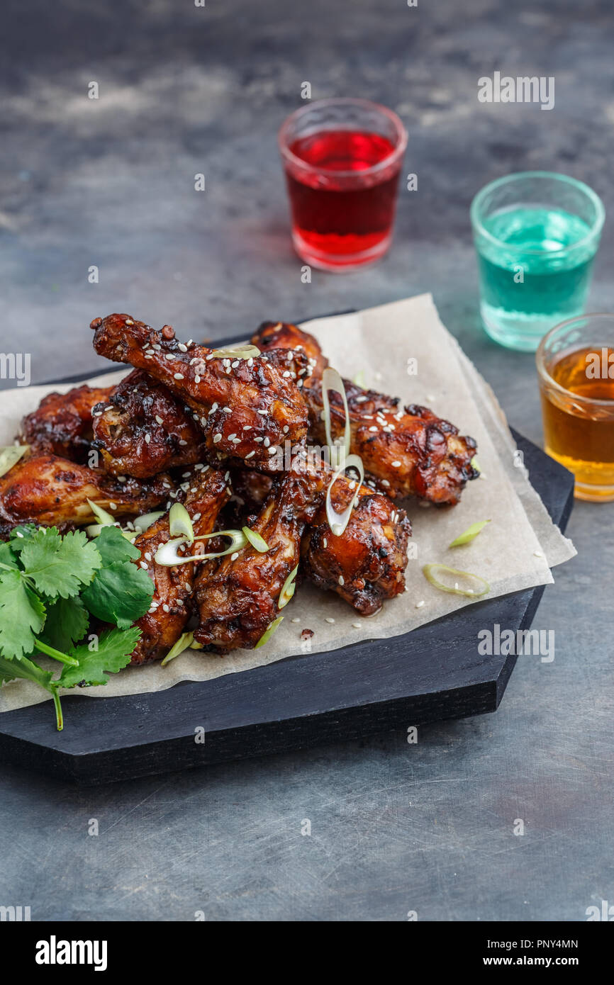 Baked chicken wings with sesame and sauce. Food background with copy space. Top view. Stock Photo