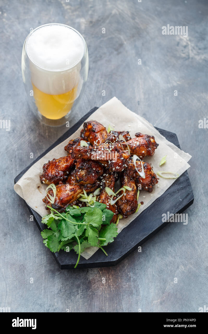 Asian chicken wings bbq with beer and coriander, copy space Stock Photo