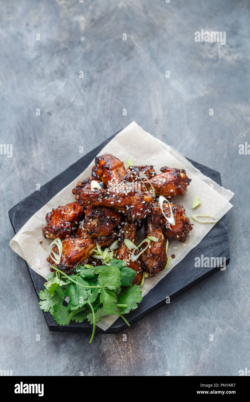 Asian chicken wings bbq with beer and coriander, copy space Stock Photo