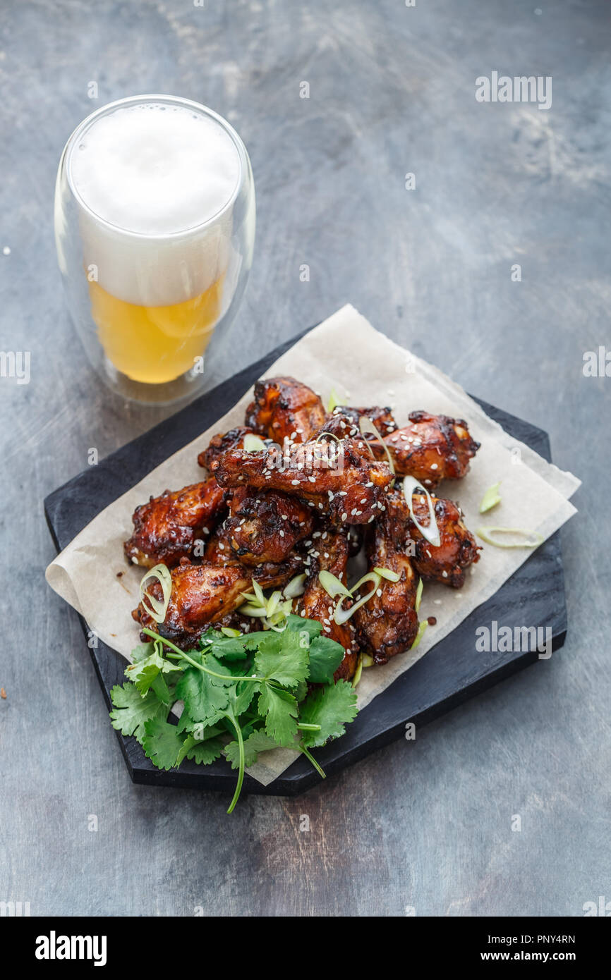Asian chicken wings bbq with beer and coriander, copy space Stock Photo