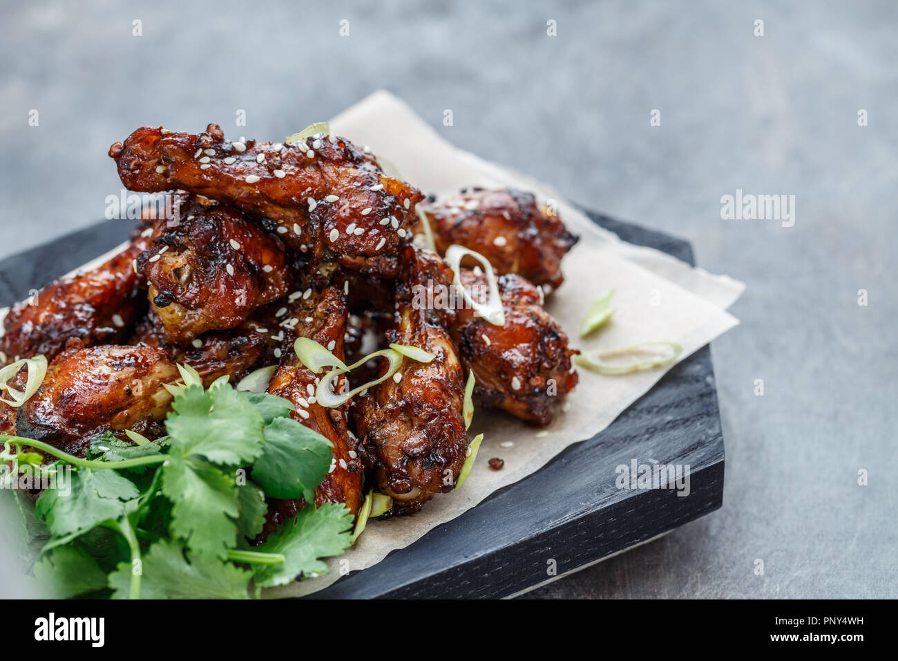 Close view of chicken wings with spicy sauce, copy space Stock Photo