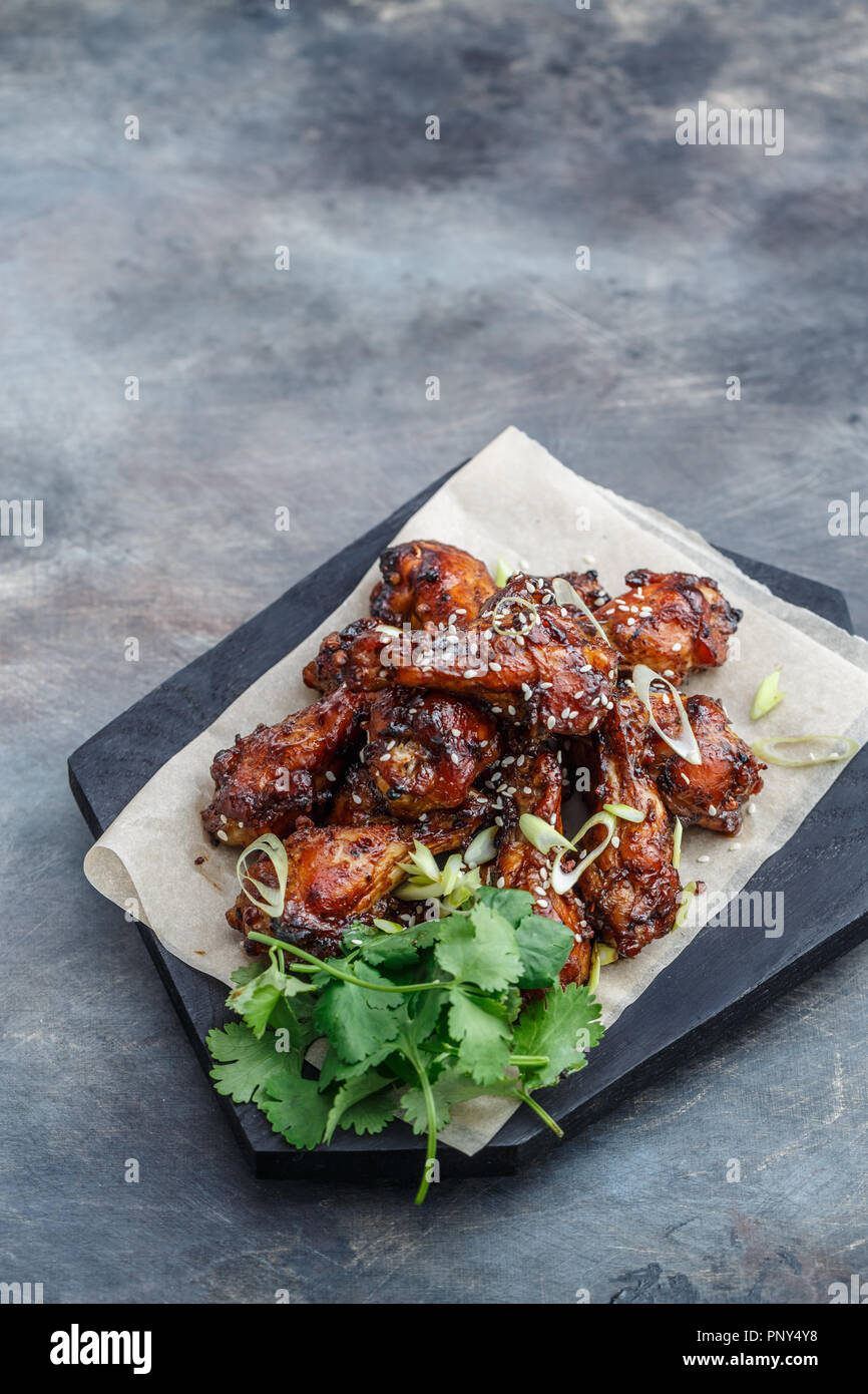 Sticky chicken wings with sesame, spicy sauce, copy space Stock Photo