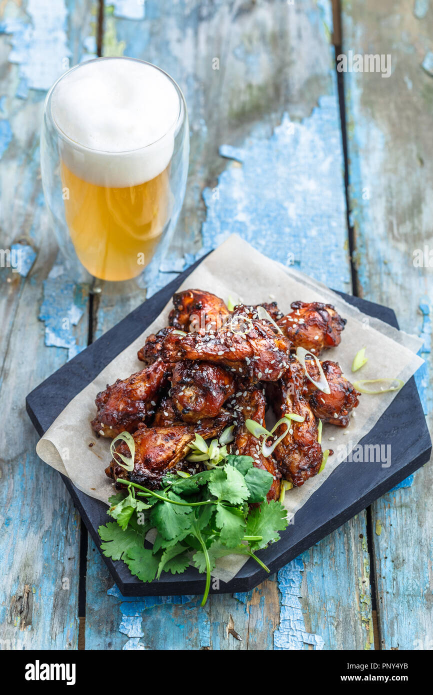 Buffalo chicken wings with beer, rustic background, copy space Stock Photo