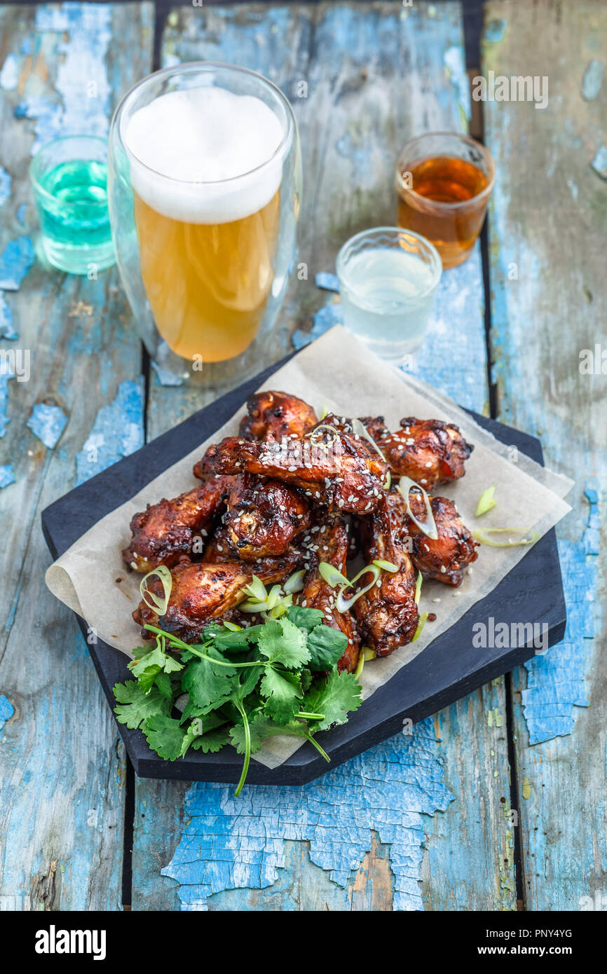 Buffalo chicken wings with beer, rustic background, copy space Stock Photo