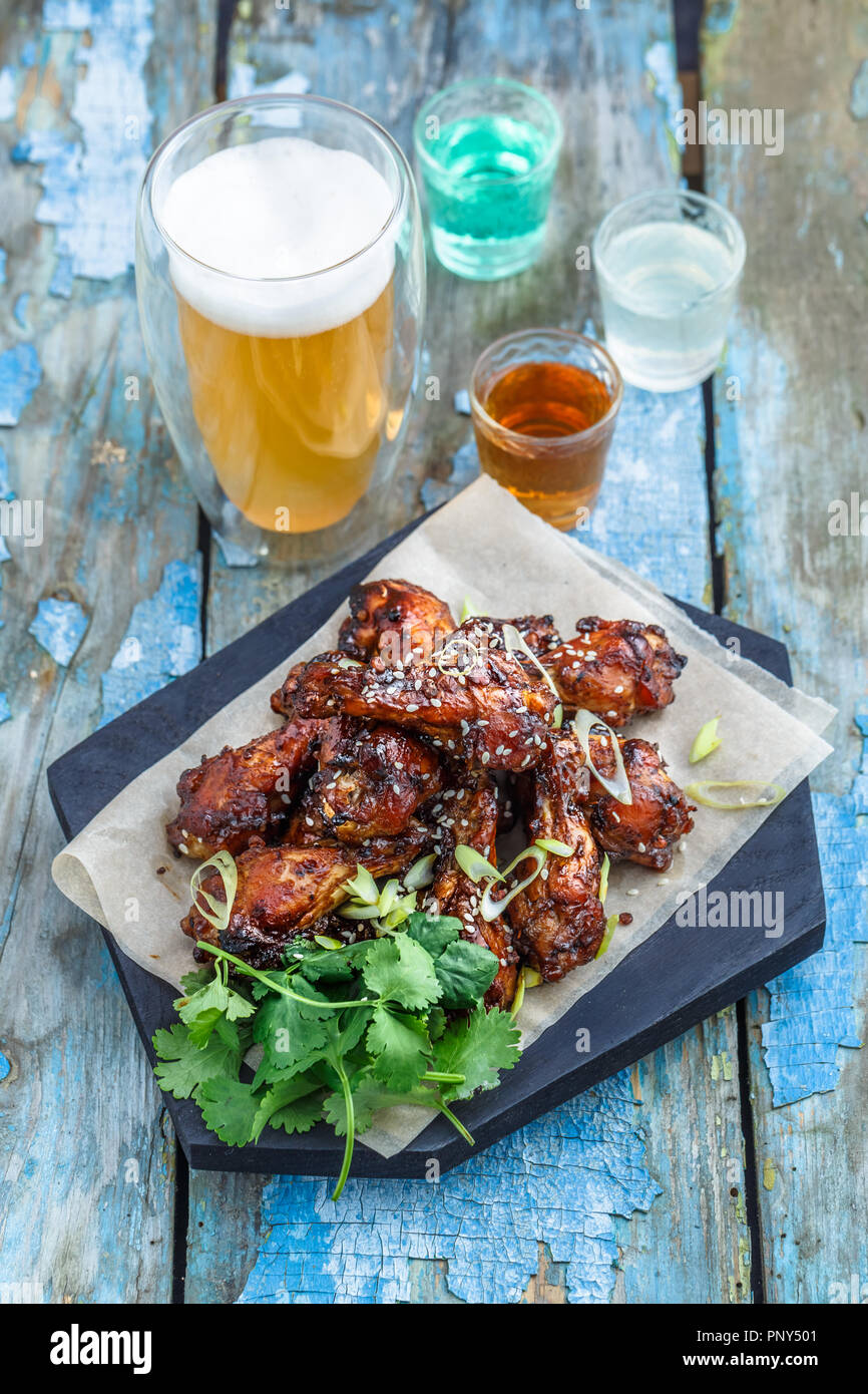 Baked chicken wings with sesame and sauce. Food background with copy space. Top view. Stock Photo