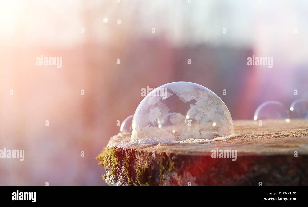 Soap bubbles freeze in the cold. Winter soapy water freezes in t Stock