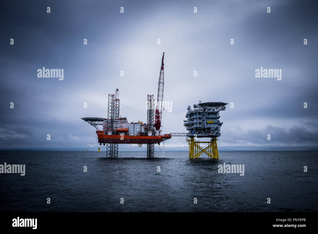 Jack Up accommodation platform, GMS Endeavour, and one of the three offshore substations during the construction phase on Hornsea Project One Offshore Wind Farm. Stock Photo