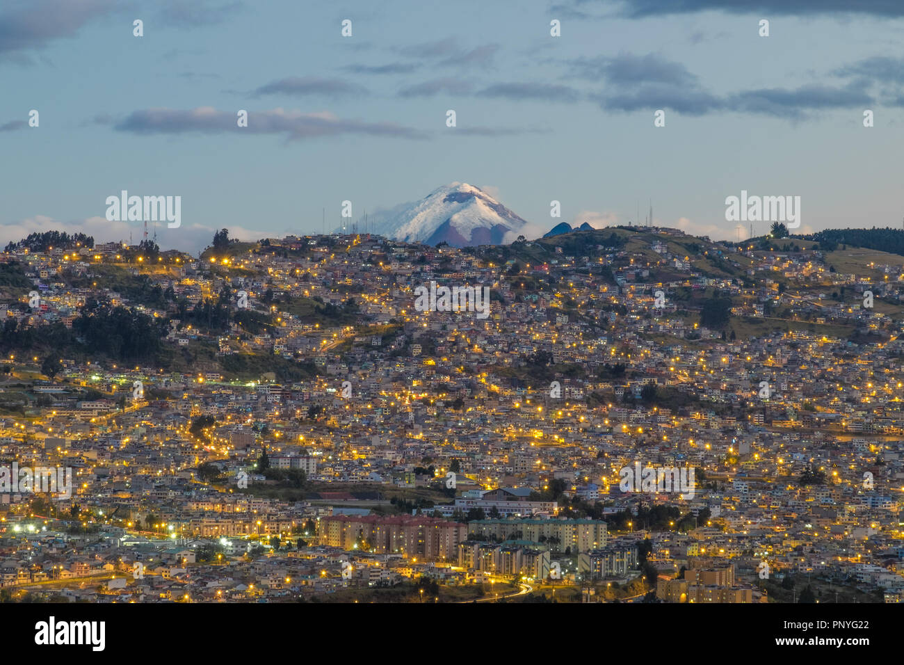 View of Quito at night and Cotopaxi volcano in the background, Ecuador Stock Photo