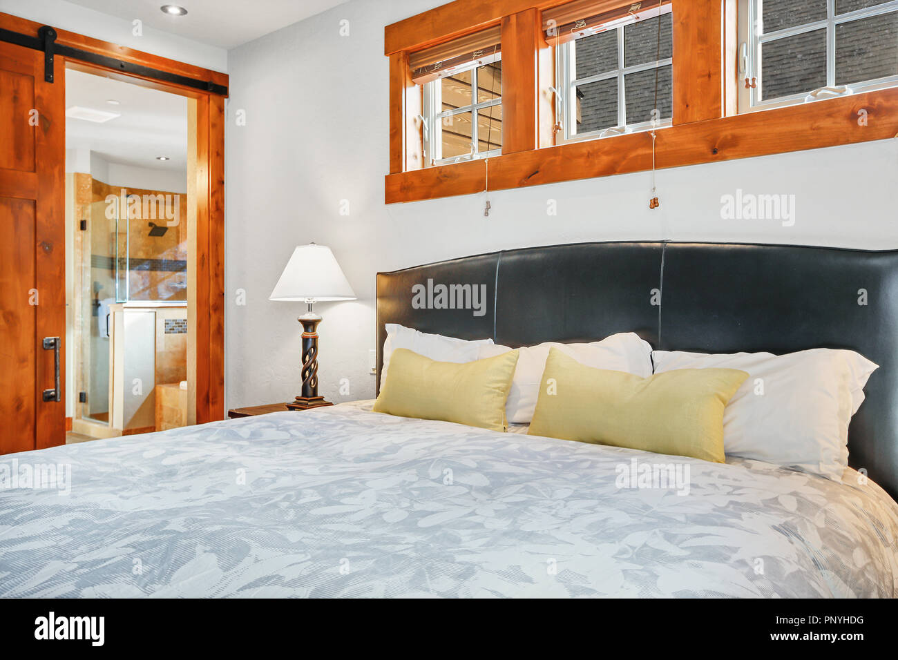 White bedroom interior with master bed and exit to back patio Stock ...