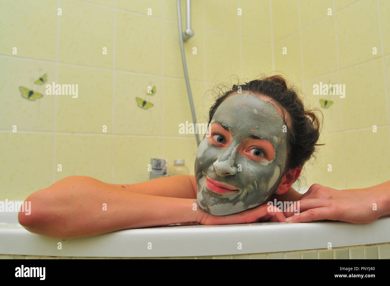 Face of young woman with mud mask in bathtub Stock Photo Alamy