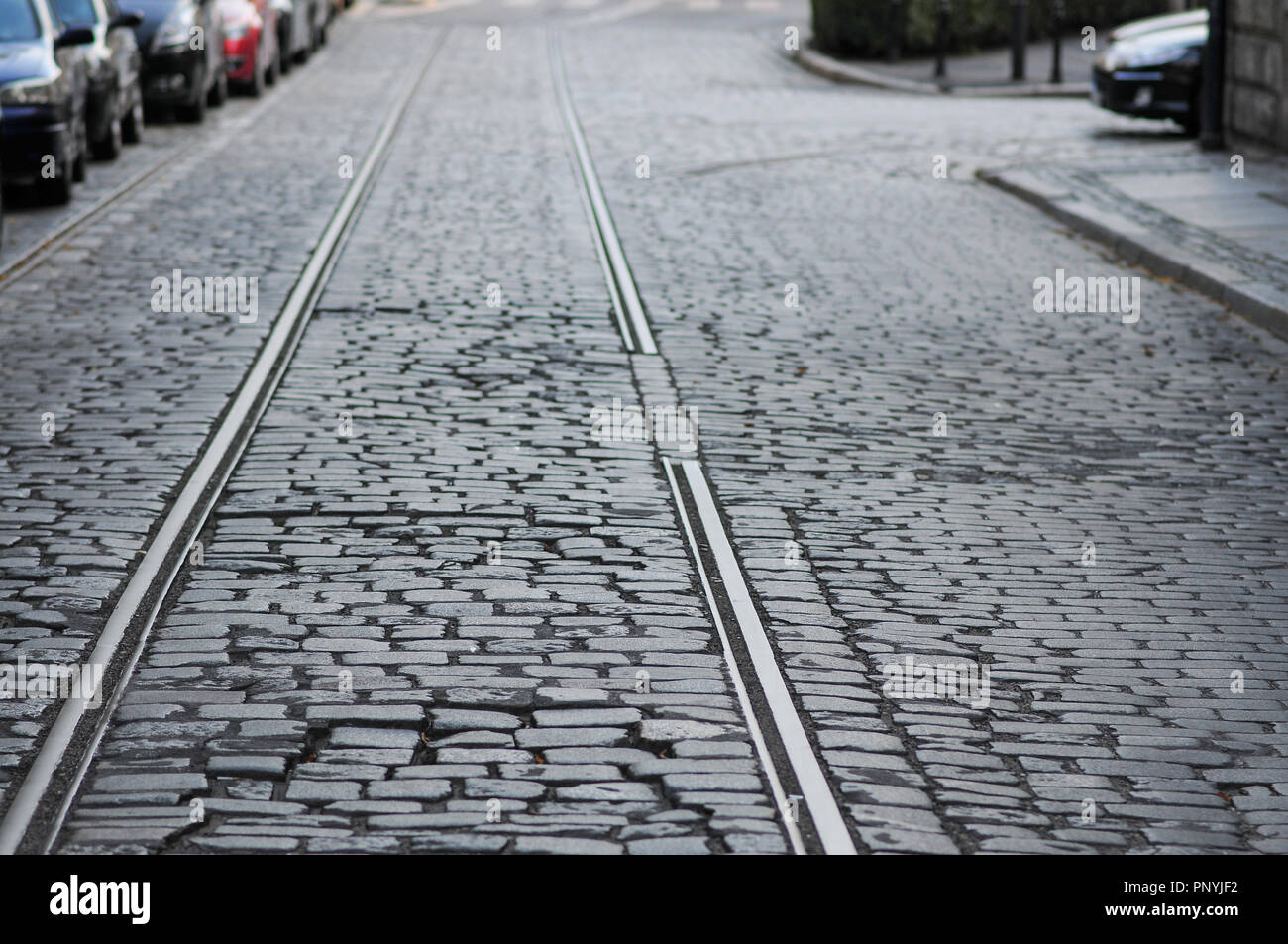 Old street with cobblestone and abandoned old broken tram tracks. Wroclaw, Poland Stock Photo