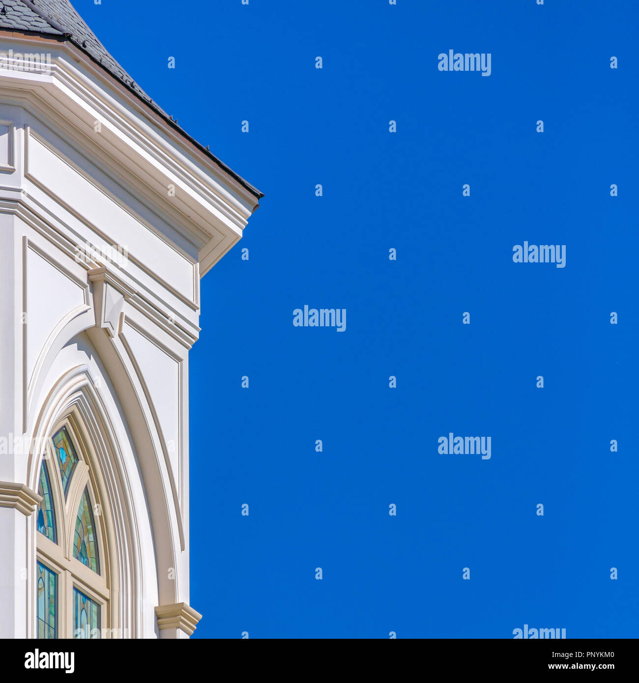 Building with decorative window against blue sky Stock Photo - Alamy