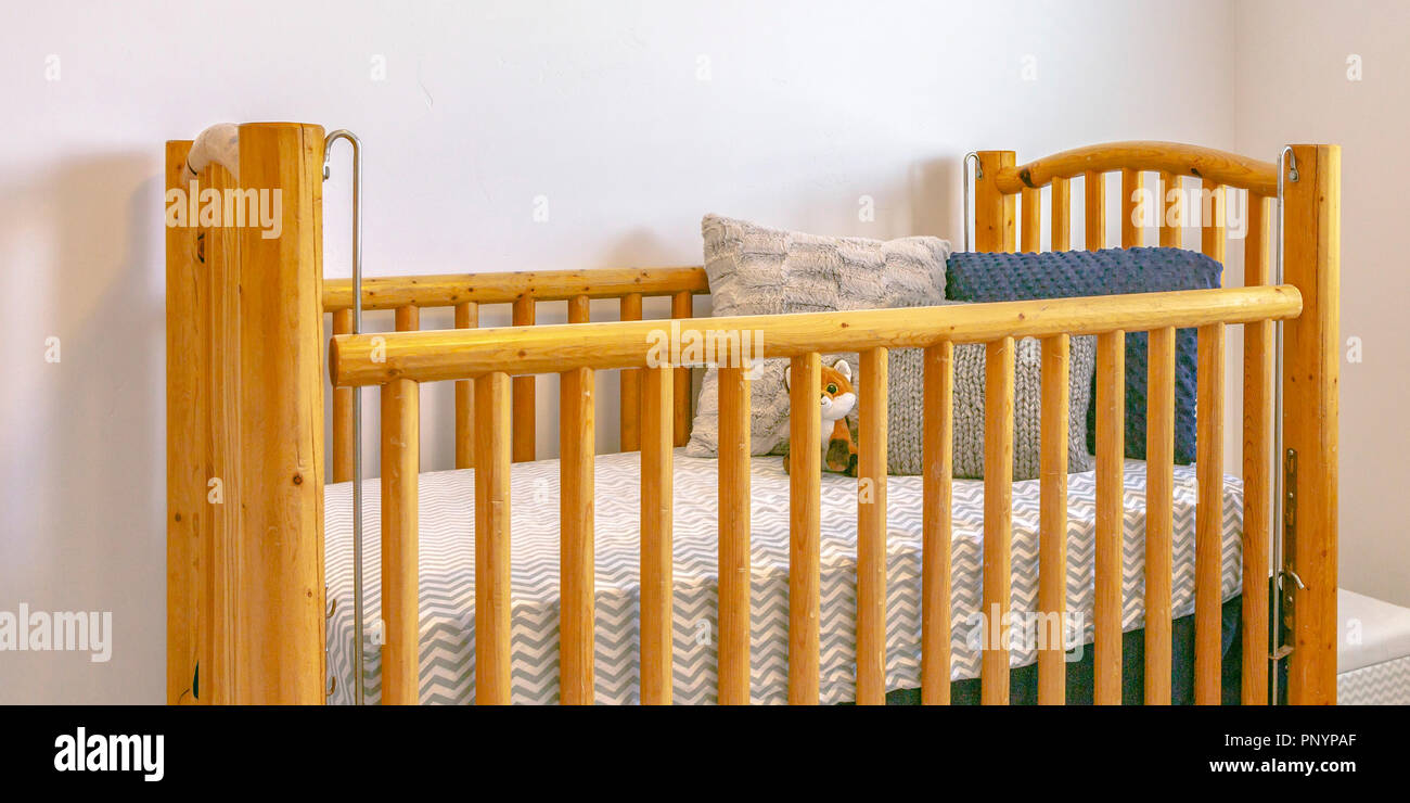 Wooden Crib With Mattress Pillows And Stuffed Toy Stock Photo