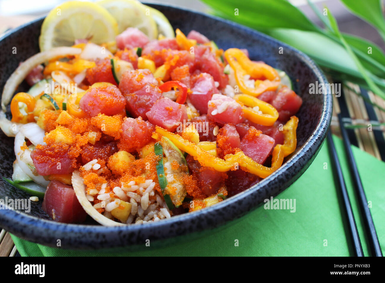 Hawaiian ahi tuna poke bowl served with white rice, vegetables and marinated tuna, close up Stock Photo