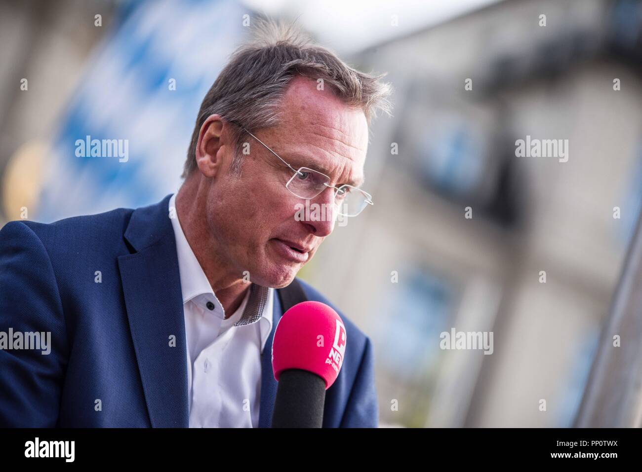 September 22, 2018 - Munich, Bavaria, Germany - MICHAEL STUERZENBERGER of the extreme-right spectrum holding a microphone of the right-extremist portal PI News. This Oktoberfest Saturday the far-right to extreme-right Alternative For Germany (AfD) party organized two rallies in the Munich city center, one at Max Joseph Platz and the second at Stachus. In attendance were numerous figures of the extreme-right spectrum, including neo-nazis, Heinz Meyer of Pegida Munich who is under terrorism monitoring, and members of the extremist Identitaere Bewegung. (Credit Image: © Sachelle Babbar/ZUMA Wire Stock Photo