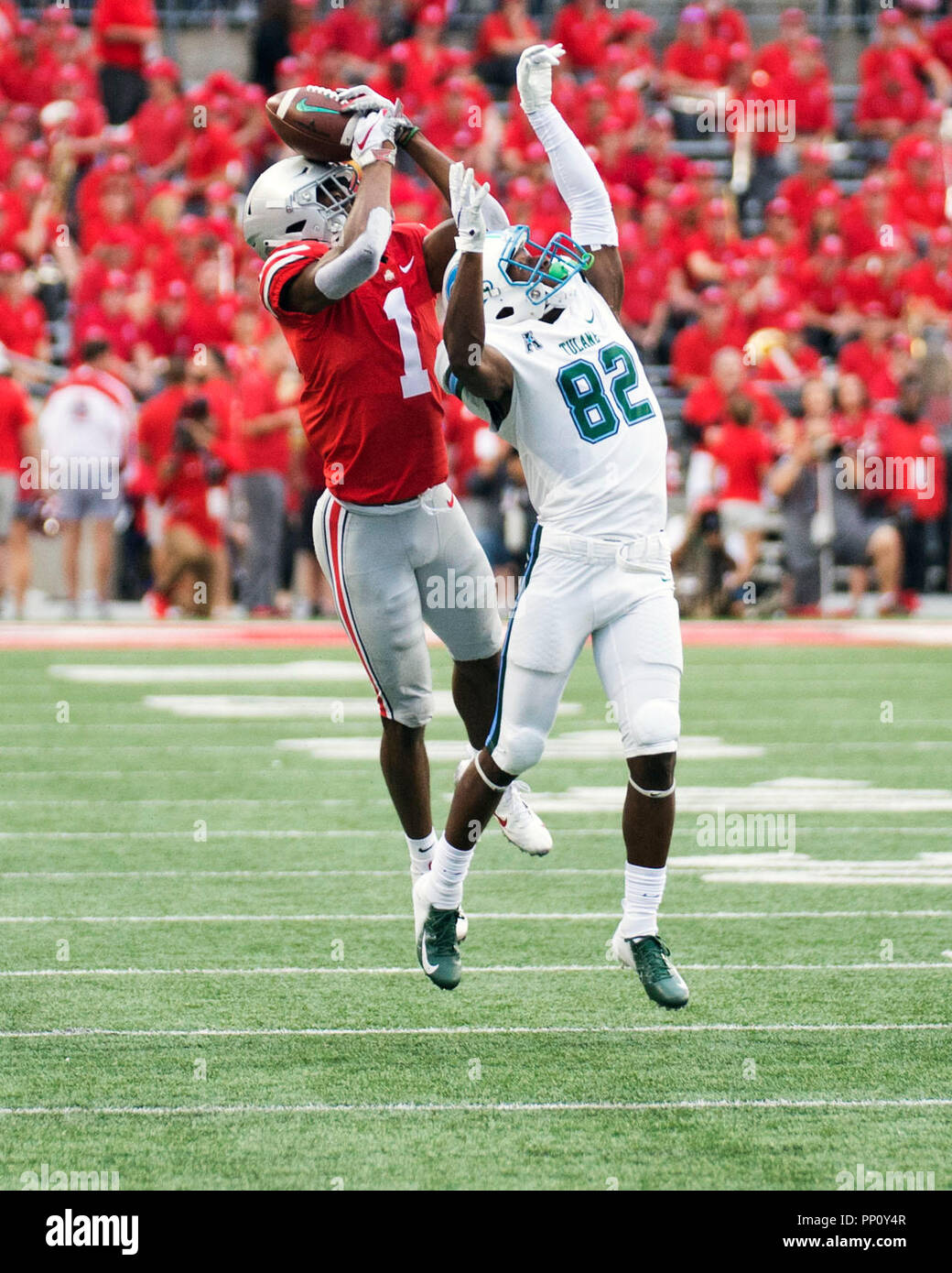 Columbus, Ohio, USA. 22nd Sep, 2018. Ohio State Buckeyes cornerback Jeffrey  Okudah (1) fights for the ball against Tulane Green Wave wide receiver  Jaetavian Toles (82) at the NCAA football game between