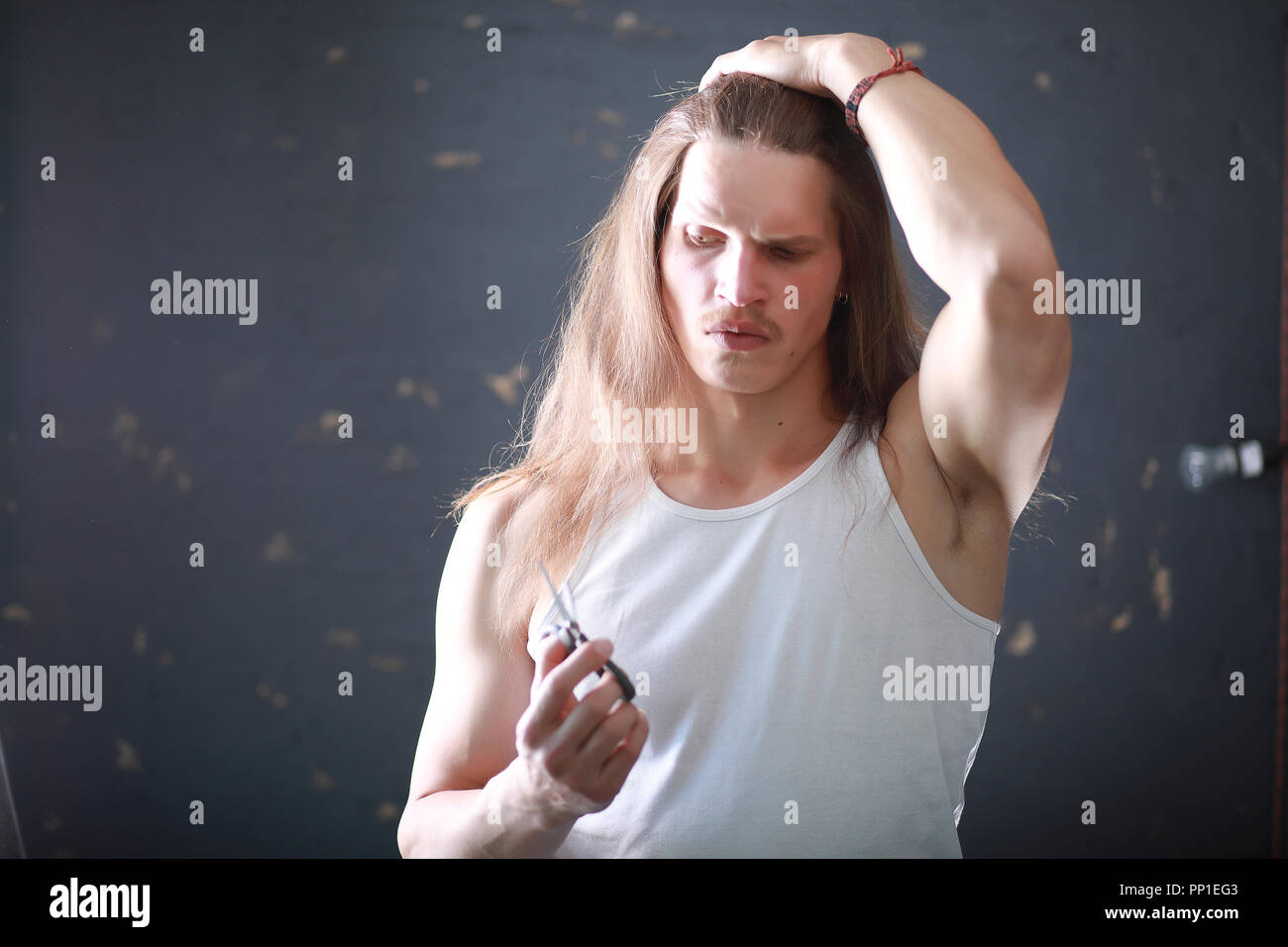 A Young Man With Long Hair Cut A Lock Stock Photo 220080227