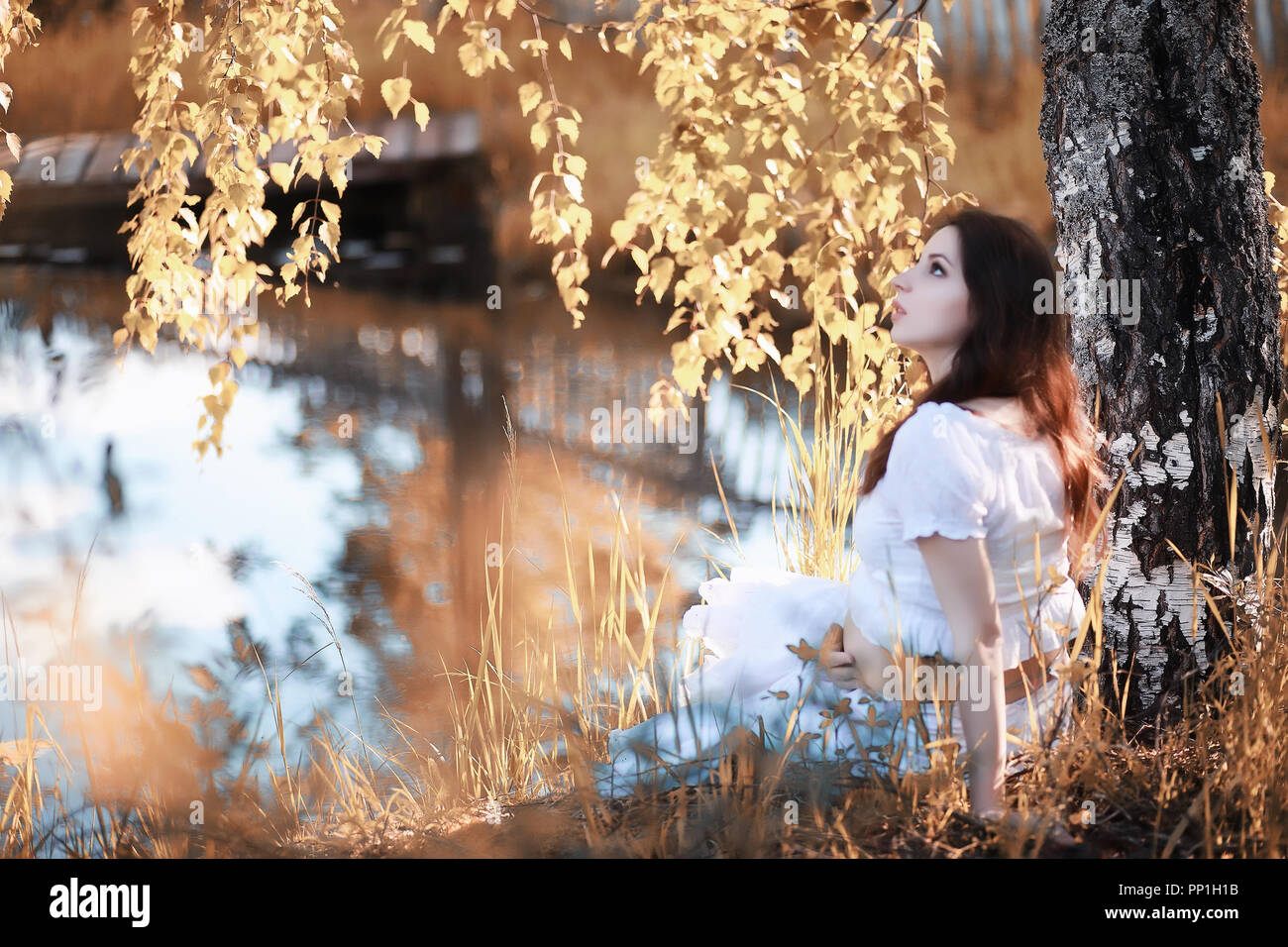 Pregnant woman in nature for a walk in the autumn Stock Photo - Alamy