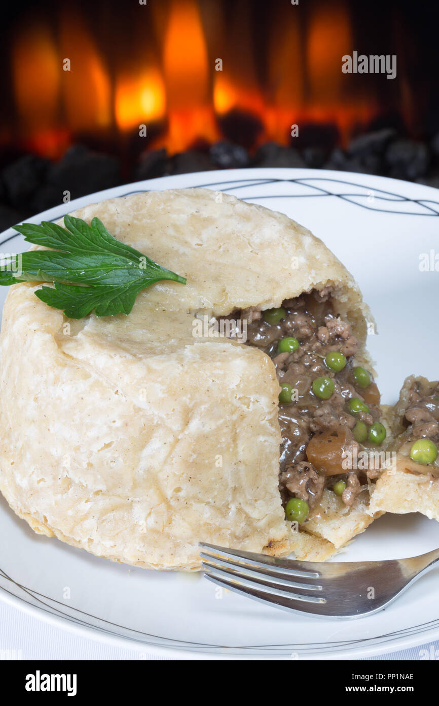 Steamed Suet pudding with savoury minced Beef and vegetable filling, Stock Photo