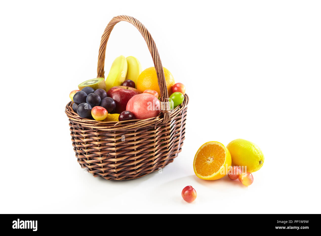 assorted fresh fruits in a basket isolated on white background, with copy space. Stock Photo