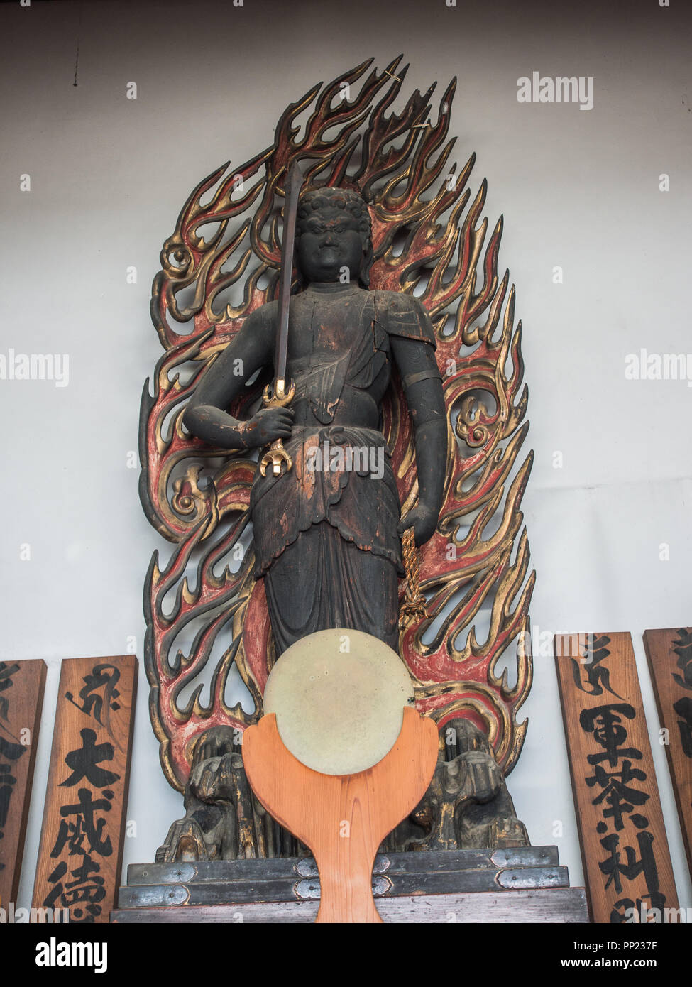 Shinto mirror and buddhist statue of Fyoo Myo-o, Kaiganiji Hondo, inner sanctuary of Zentsuji, Kagawa, Japan Stock Photo