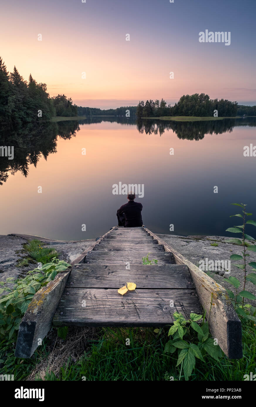 Scenic tranquil landscape with wooden stairs and sunset at autumn evening in Finland Stock Photo