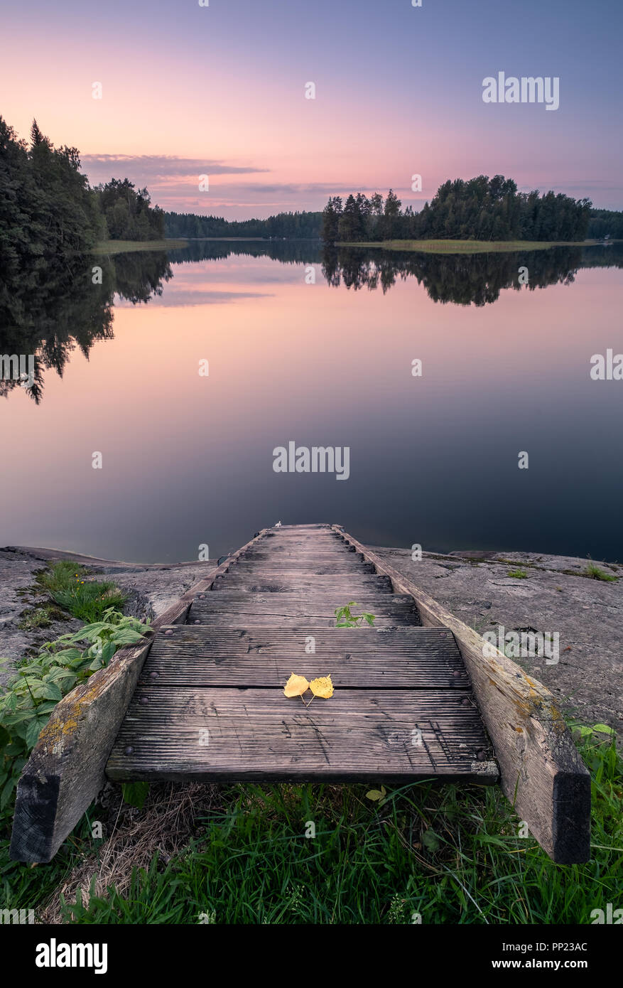 Scenic tranquil landscape with wooden stairs and sunset at autumn evening in Finland Stock Photo