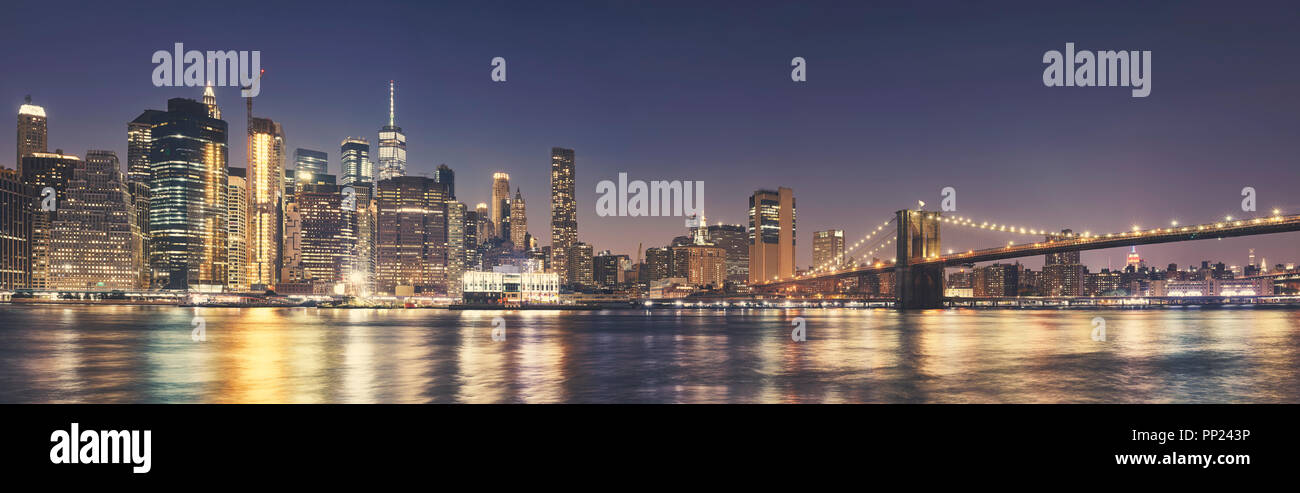 Manhattan skyline and the Brooklyn Bridge at night, color toning applied, USA. Stock Photo