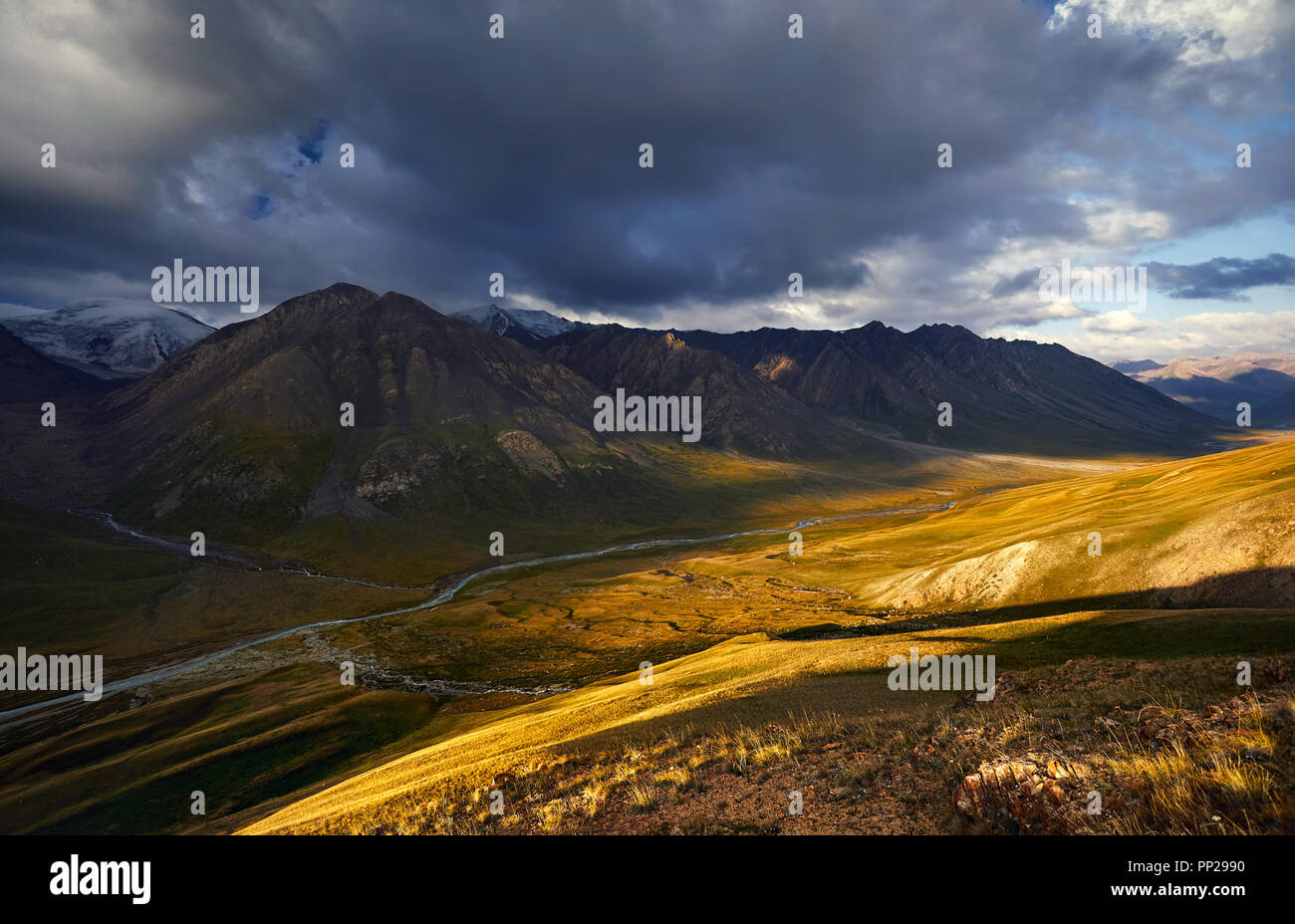 Beautiful landscape of mountain valley at sunrise cloudy sky of Terskey Alatau in Kyrgyzstan Stock Photo